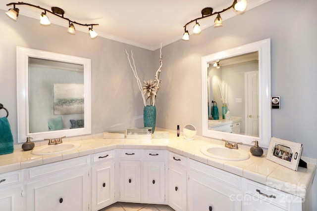 bathroom with vanity, ornamental molding, and tile patterned floors