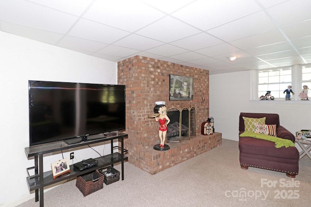 carpeted living room with a paneled ceiling and a fireplace