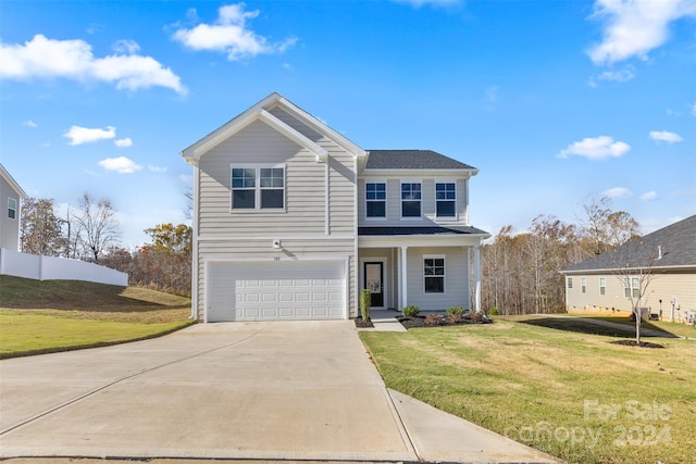 183 Sugar Hill Rd, Troutman, NC 28166 - traditional-style house featuring a garage, driveway, a front lawn, and a porch
