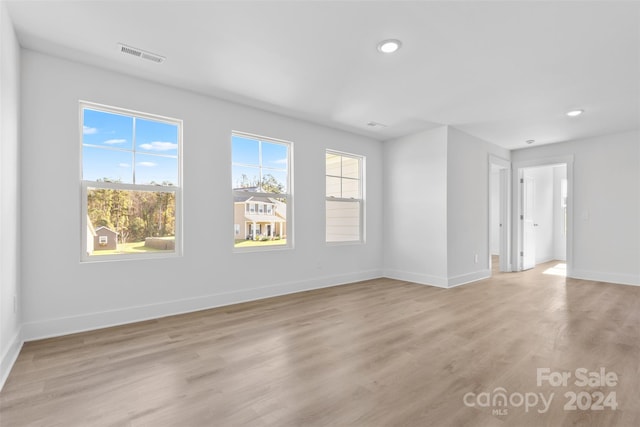 unfurnished room with light wood-type flooring