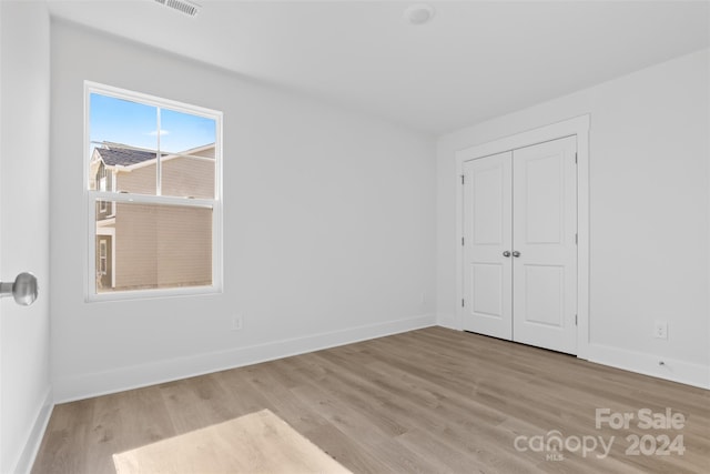 183 Sugar Hill Rd, Troutman, NC 28166 - unfurnished bedroom with wood finished floors, baseboards, and a closet