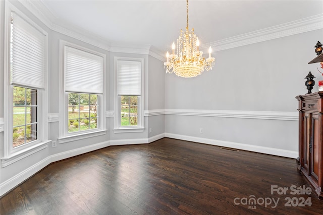 unfurnished dining area featuring dark hardwood / wood-style flooring, an inviting chandelier, and ornamental molding