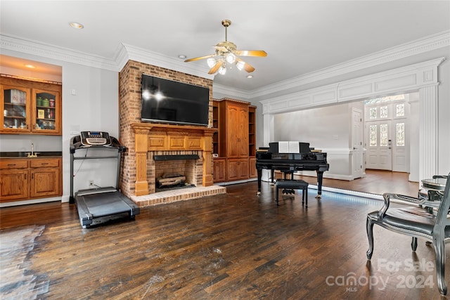 living room featuring a fireplace, ceiling fan, dark hardwood / wood-style floors, and crown molding