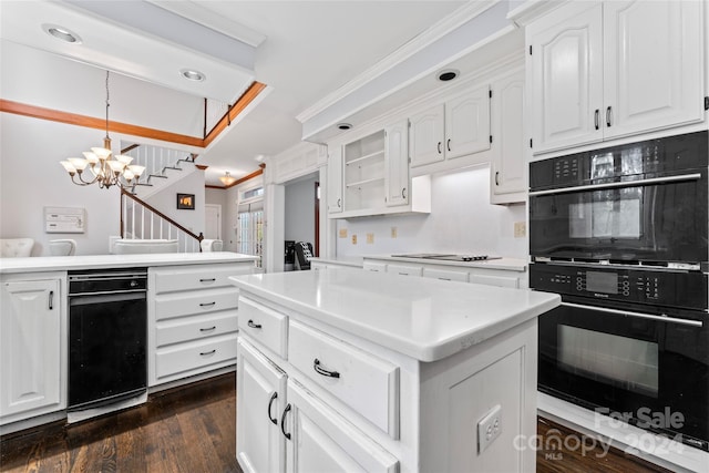 kitchen featuring dark wood-type flooring, white cabinetry, pendant lighting, and double oven