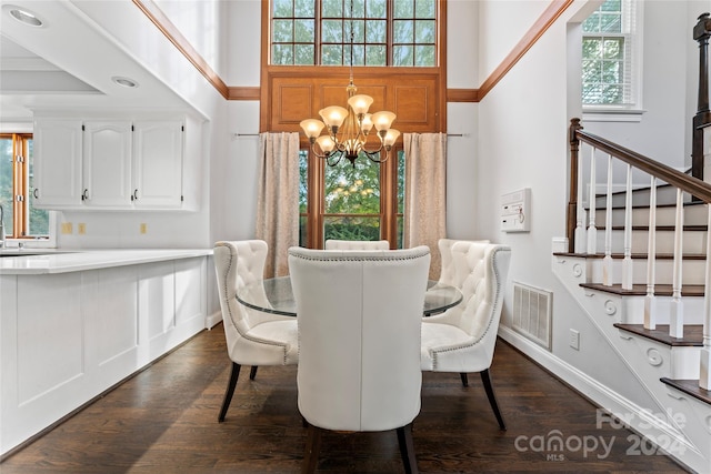 dining space featuring a wealth of natural light, dark hardwood / wood-style flooring, and a notable chandelier