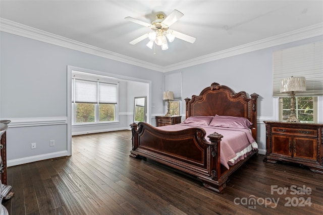 bedroom featuring dark wood-type flooring, ornamental molding, and ceiling fan