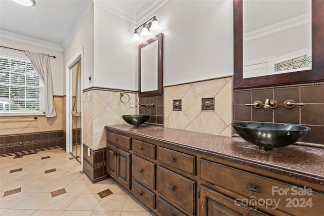 bathroom featuring tile patterned flooring, vanity, and crown molding