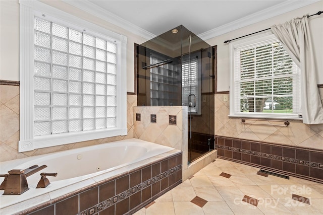 bathroom with independent shower and bath, tile patterned flooring, and a healthy amount of sunlight