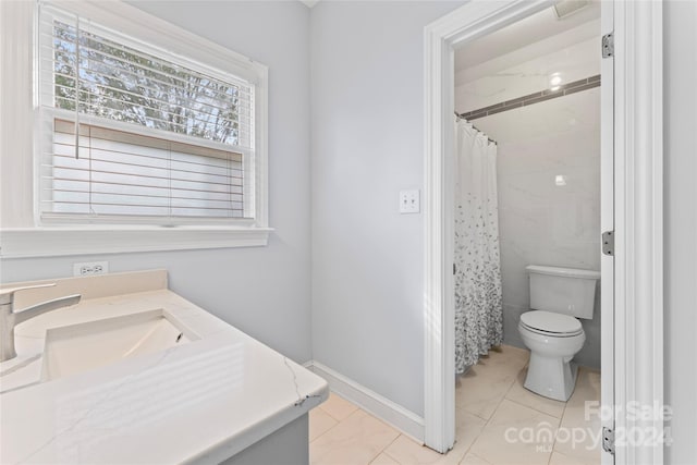 bathroom featuring a shower with shower curtain, tile patterned floors, vanity, and toilet