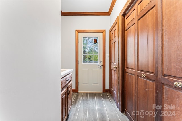 entryway featuring light hardwood / wood-style flooring and ornamental molding