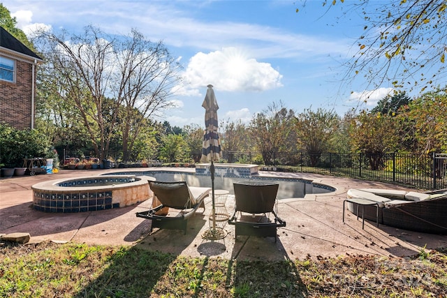 view of patio featuring a swimming pool with hot tub