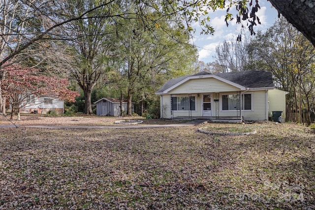 view of front of property with a shed and a porch