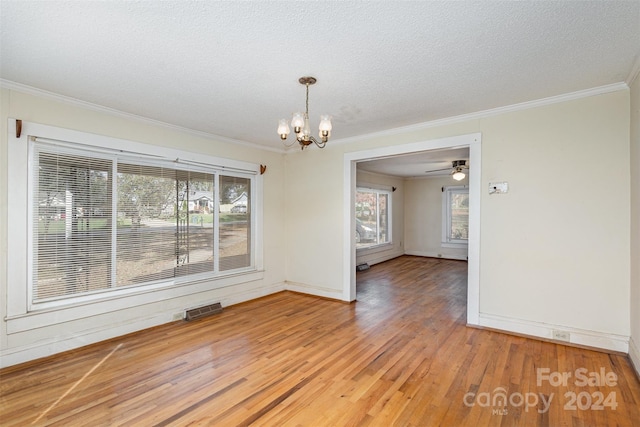 unfurnished dining area featuring wood-type flooring, a wealth of natural light, and crown molding