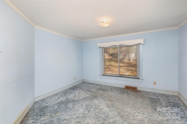 empty room with carpet floors, a textured ceiling, and ornamental molding