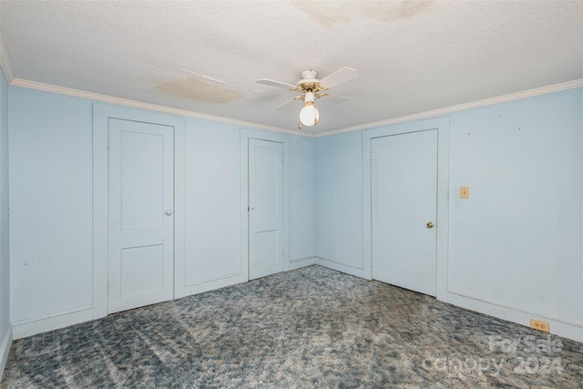 unfurnished bedroom featuring a textured ceiling, dark carpet, ceiling fan, and crown molding