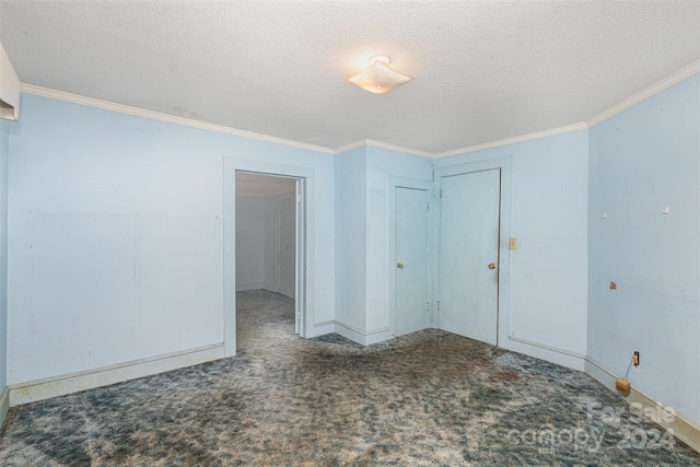 carpeted spare room with crown molding and a textured ceiling