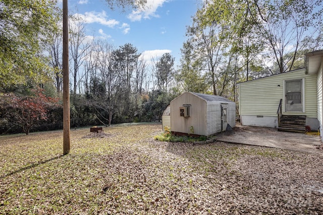 view of yard with a patio and a storage shed