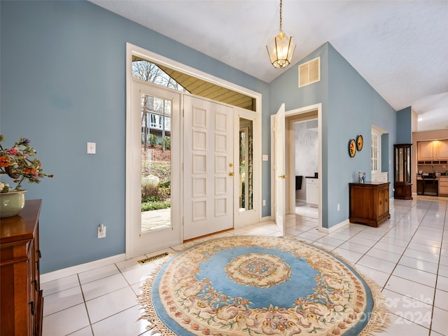 foyer entrance featuring lofted ceiling and light tile patterned floors