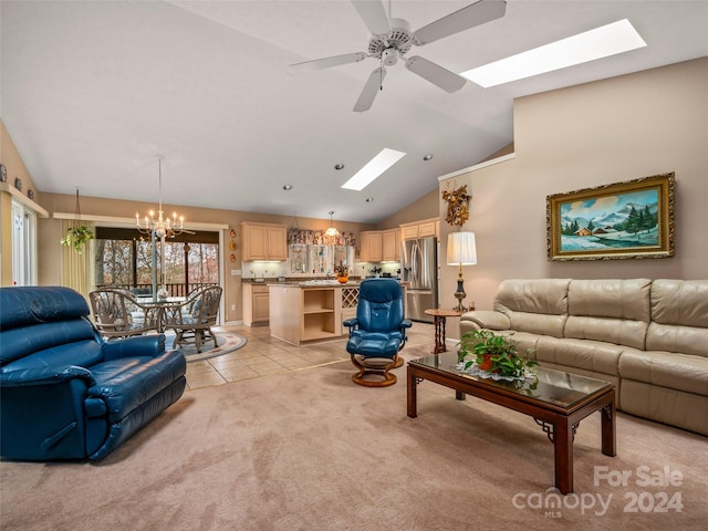 living room featuring vaulted ceiling with skylight, light carpet, and ceiling fan with notable chandelier