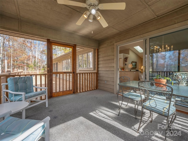 sunroom featuring ceiling fan and a skylight