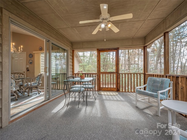 unfurnished sunroom with ceiling fan