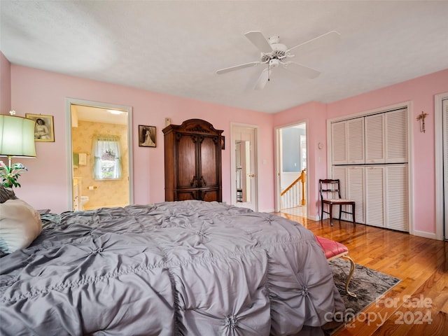 bedroom with ceiling fan, ensuite bath, and wood-type flooring