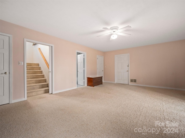 carpeted empty room with ceiling fan