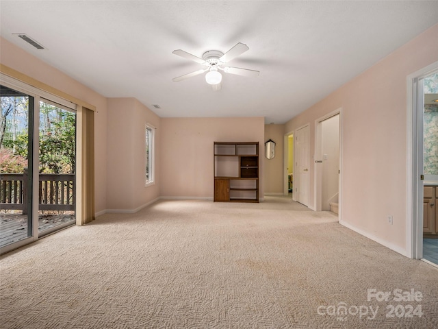 unfurnished living room featuring ceiling fan and light carpet