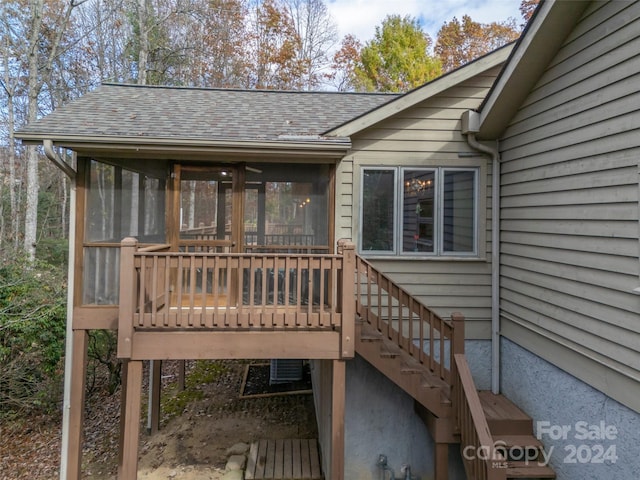 wooden deck featuring a sunroom