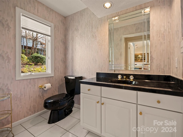 bathroom featuring vanity, tile patterned floors, and toilet