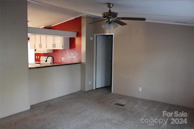 kitchen with white cabinets, ventilation hood, vaulted ceiling, and carpet floors