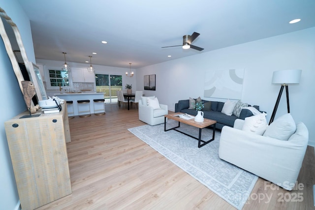 living room featuring ceiling fan and light wood-type flooring