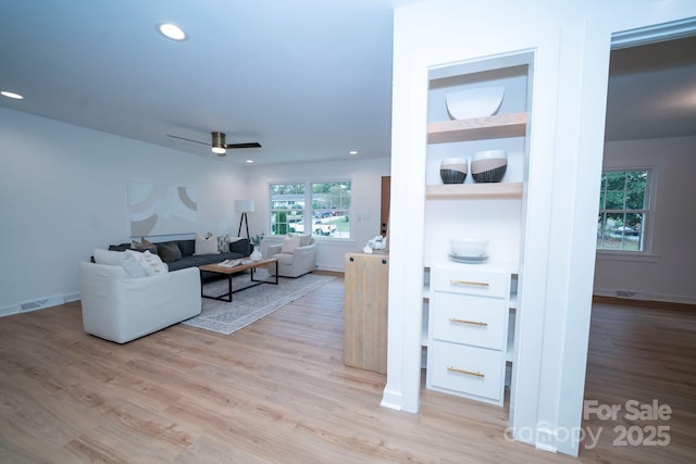 living room featuring ceiling fan and light wood-type flooring