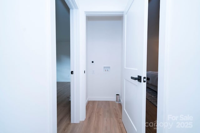 hallway with light hardwood / wood-style floors