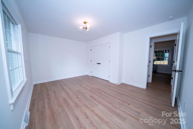 unfurnished room with light hardwood / wood-style floors