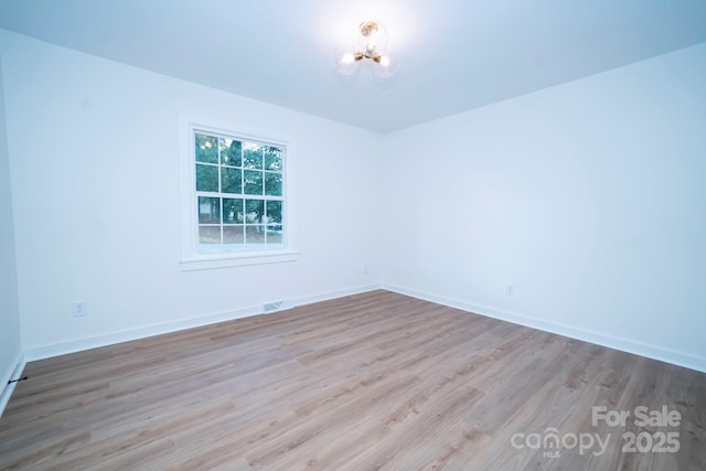 unfurnished room with light hardwood / wood-style floors