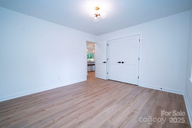 unfurnished bedroom with light hardwood / wood-style floors and a closet