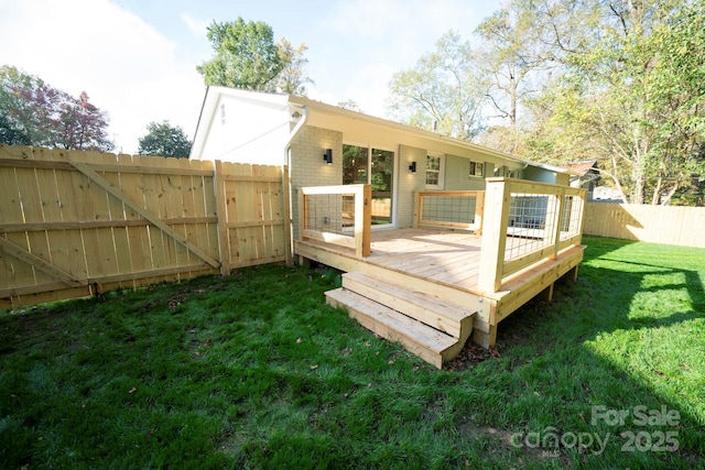 rear view of house with a deck and a yard