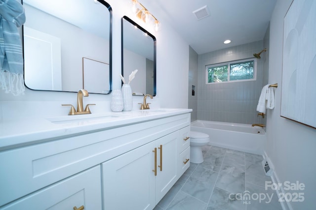 full bathroom featuring toilet, vanity, and tiled shower / bath