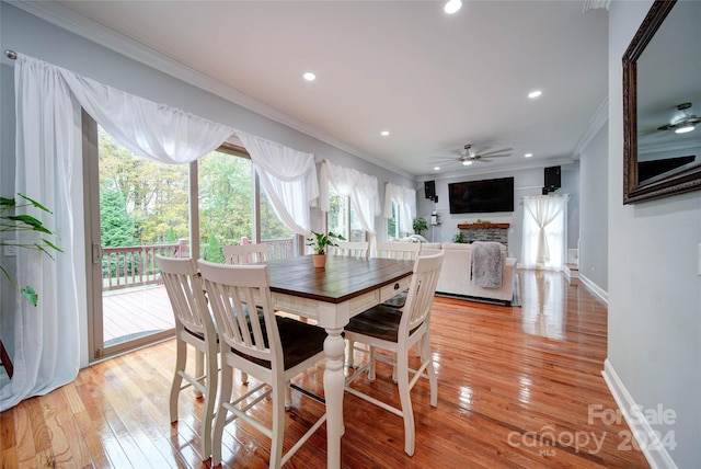 dining room with light hardwood / wood-style floors, ceiling fan, and ornamental molding