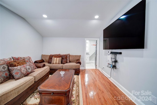 living room featuring hardwood / wood-style floors and lofted ceiling