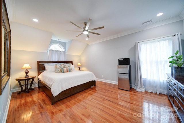 bedroom with lofted ceiling, ceiling fan, stainless steel fridge, ornamental molding, and wood-type flooring