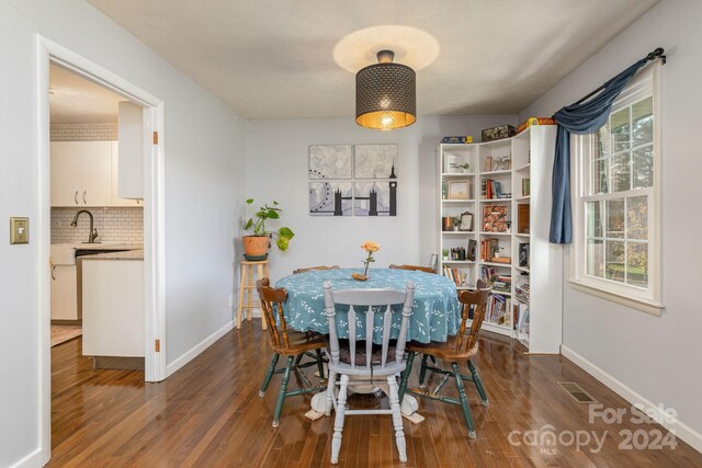 dining area featuring dark hardwood / wood-style flooring, sink, and plenty of natural light