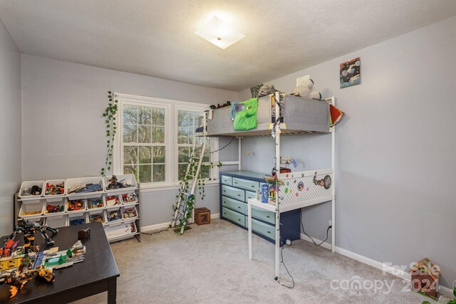 carpeted bedroom featuring a textured ceiling