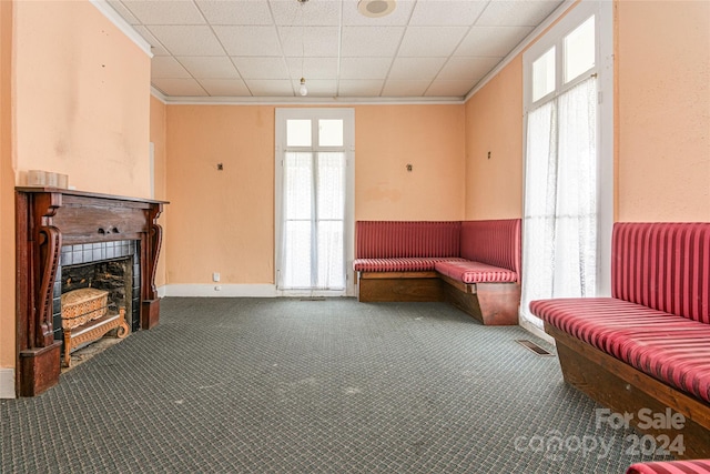 sitting room featuring a paneled ceiling, a wealth of natural light, carpet, and ornamental molding