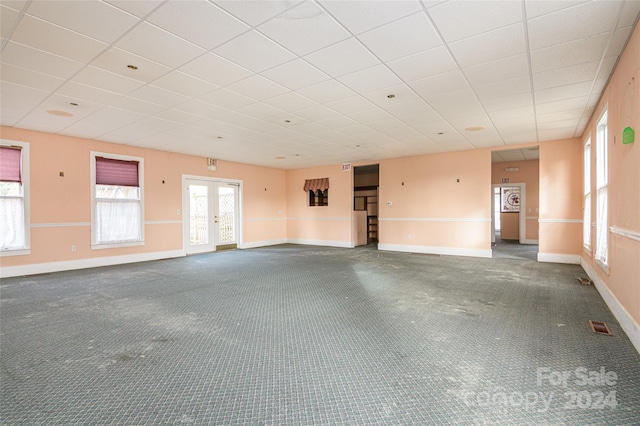 empty room with carpet flooring and french doors