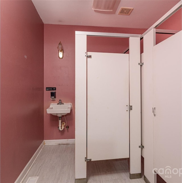 bathroom featuring sink and hardwood / wood-style flooring