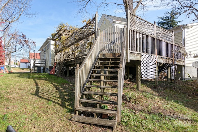 rear view of property with a yard and a wooden deck