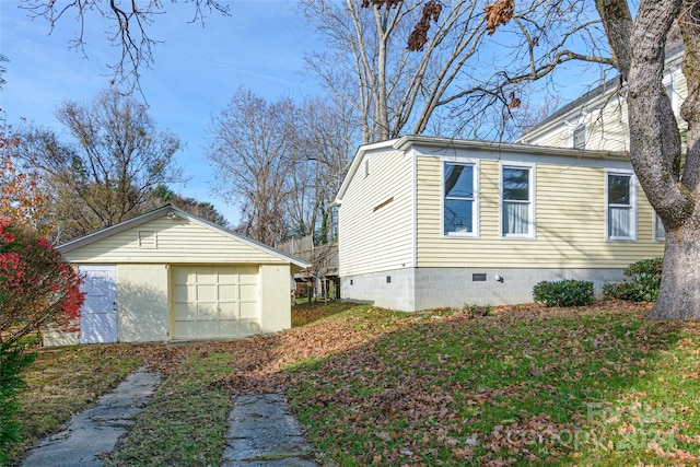 view of side of home with a garage and an outdoor structure