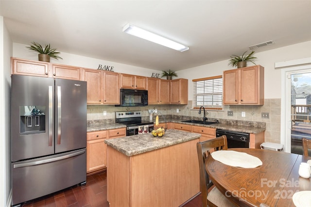 kitchen featuring sink, dark hardwood / wood-style flooring, decorative backsplash, a kitchen island, and black appliances